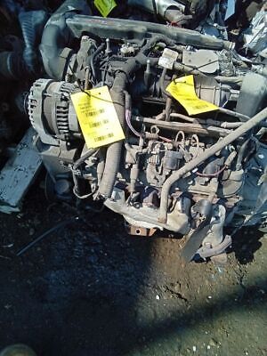 A car engine with some yellow tags on it