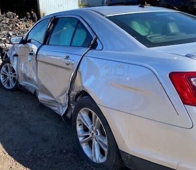 A white car that has been smashed in the back.