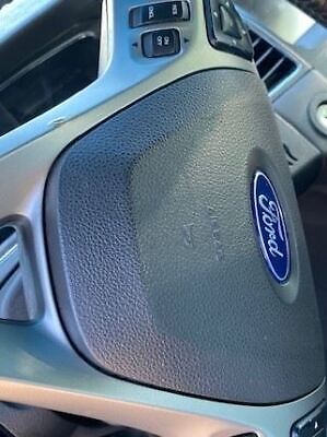 A close up of the steering wheel on a car