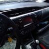 A car dashboard with the steering wheel and dash.