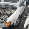 A white car that has been smashed in the back of it.