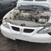 A white car with the hood up and engine exposed.