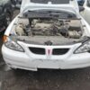 A white car with the hood up and engine exposed.