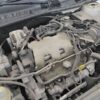 A car engine with many wires attached to it.