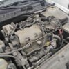A car engine with many wires attached to it.