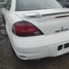 A white car with the tail lights on.