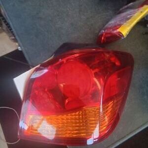 A red and yellow car tail light on top of a table.