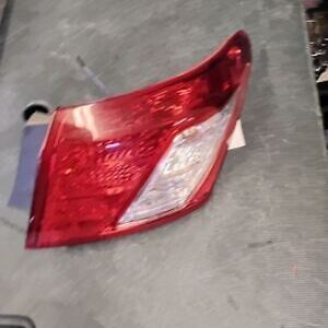 A red and white car tail light on the floor