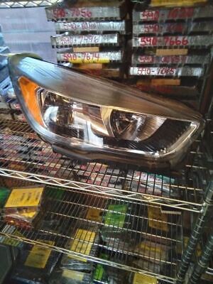 A car headlight sitting on top of a shelf.