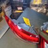 A red car is parked in the garage