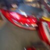 A blurry picture of a red car in motion.