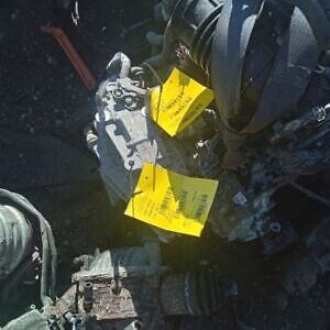 A yellow sign is on the ground near some debris.