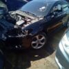 A car that has been wrecked in the street.