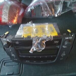 A car radio with some yellow stickers on it