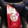 A black leather chair with a red and white light.