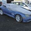A blue car with some white tarps on it