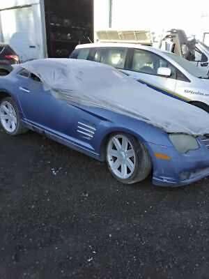 A blue car with some white tarps on it