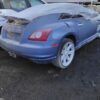 A blue car with some damage on the hood