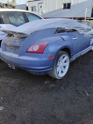 A blue car with some damage on the hood