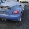 A blue car with some damage on the hood