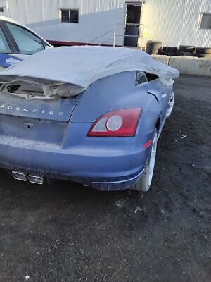 A blue car with some damage on the hood