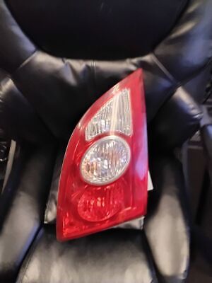 A red and white car tail light on top of black leather.