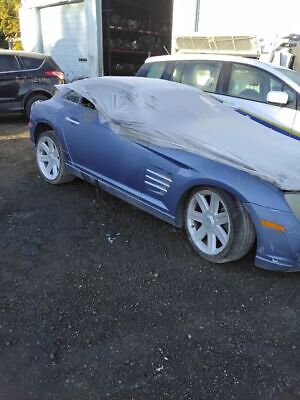 A blue car with some white tarps on it