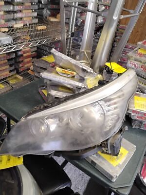 A car headlight is being worked on in the shop.