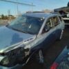 A silver car that has been smashed in the back of it.