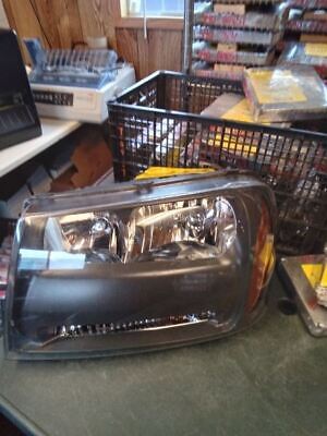 A car headlight sitting on top of the floor.