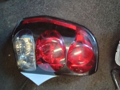 A car 's tail light is shown with the bulb lit.