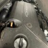 A car engine with the hood open and the lid closed.