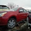A red car is parked in the lot
