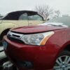 A red car is parked in the parking lot