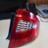 A red and white car tail light on top of a table.