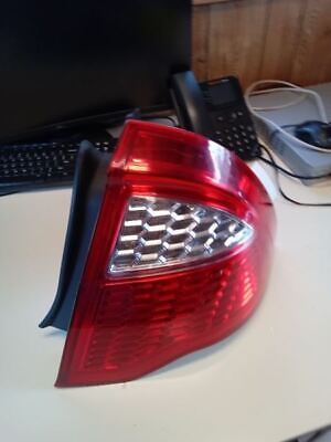 A red and white car tail light on top of a table.