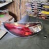 A red and silver car tail light on top of a table.