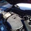 A car engine with the hood open.