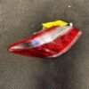 A red and white car tail light on the floor