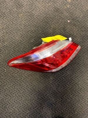 A red and white car tail light on the floor