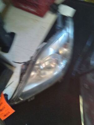 A car 's headlight is broken and has been repaired.