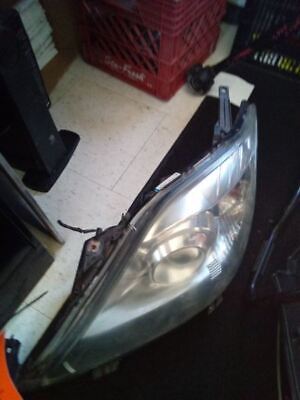 A car headlight with the hood up.