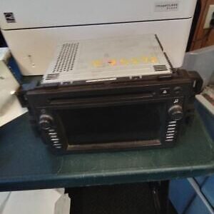 A black and silver car stereo sitting on top of a table.