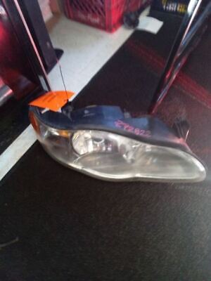 A car headlight with an orange tag on it.