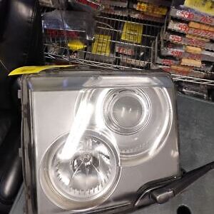 A silver car headlight sitting on top of a table.