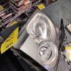 A silver car headlight sitting on top of a table.