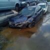 A car that has been wrecked in the water.