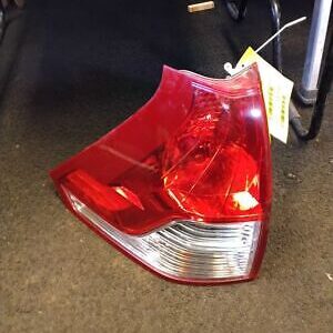 A red and white car tail light on the floor