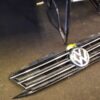 A volkswagen logo is shown on the grill of an automobile.
