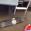 A table and chairs in the background with a vw logo on it.